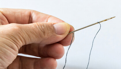 Hand holding a needle and thread