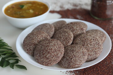 Ragi Idli served with sambhar. A nutritious South Indian staple made with fermented batter of unpolished finger millet and deskinned black gram