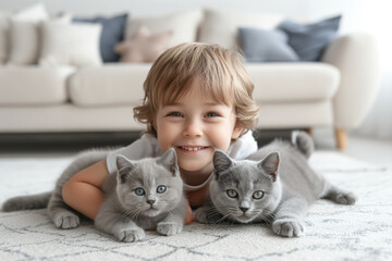 Little boy lying on floor with two cats, in living room