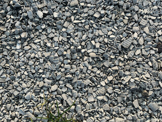 Small road stone background. Gravel pebbles stone texture. Seamless texture