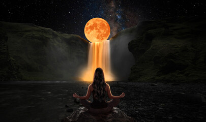 Woman in yoga position in front of the full moon
