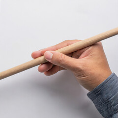 hand holding a wooden stick