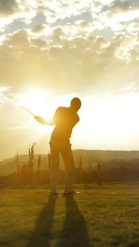 Golf Player plays golf on a beautiful summer morning. wide angle Lens flare Back lite shot - vertical for story and reel
