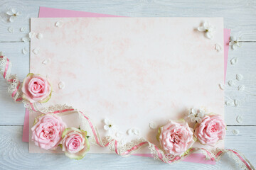White and pink paper with flowers of pink roses, blooming cherry plum, lace ribbon for text greeting, invitation. Card for wedding, Mother's day, birthday - 708069939