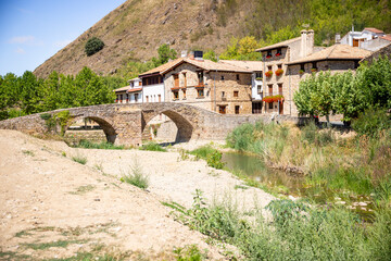 Fototapeta na wymiar Roman bridge over Elorz river in Monreal (Elo) village, Navarra, Spain
