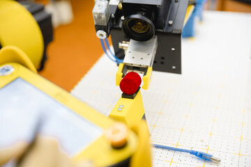 A robot in a laboratory equipped with a machine vision camera works with hazardous substances.