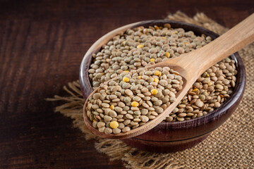 Green lentils in the bowl on the table.