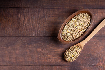 Green lentils in the bowl on the table.