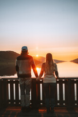 Couple in love holding hands walking together Valentines day romantic dating family travel lifestyle relationship man and woman outdoor sunset lake landscape boyfriend and girlfriend - obrazy, fototapety, plakaty