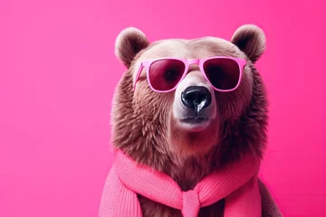 Fototapeten photo Brown bear portrait with pink glasses. banner with pink Peach Fuzz background © Al