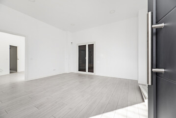 Hallway of a loft-type home with gray armored access door