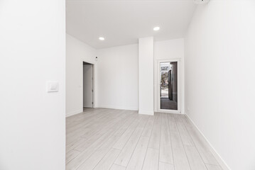 Obraz premium A newly installed loft-style home with light gray parquet floors, glass and white aluminum doors