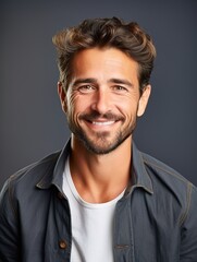 Handsome bearded man smiling on gray background, happy man