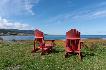 Red chairs at Rocky Harbor in Gros Morne National Park, a Canadian national park and World Heritage...