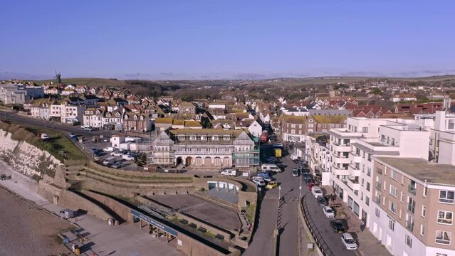 Aerial footage from the sea heading towards Rottingdean village in East Sussex, and the high street looking towards the centre of the village.
