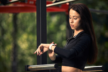 Photo of young european woman on a street workout in sports park on sunny day. Concept of training outdoor.
