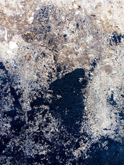 Dirty cement wall with black paint stains. Abstract black paint grunge background with copy space.