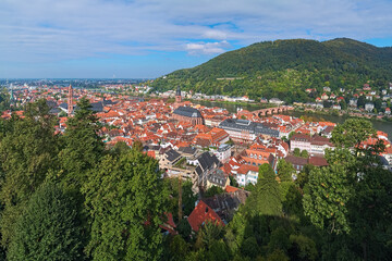 Heidelberg, Germany. High angle view over the Heidelberg Old Town with Jesuit Church, Church of the Holy Spirit and Old Bridge (Karl Theodor Bridge) across the Neckar river. - 708099577