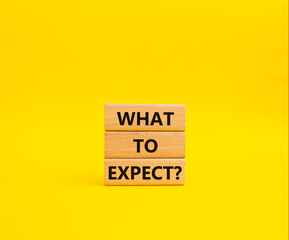 What to Expect symbol. Concept words What to Expect on wooden blocks. Beautiful yellow background. Business and What to Expect concept. Copy space.