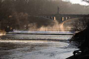 Munich, Germany - December 19 2021: Bridge on the Isar river on winter day.