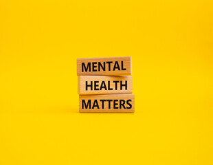 Mental Health Matters symbol. Concept words Mental Health Matters on wooden blocks. Beautiful yellow background. Healthcare and Mental Health Matters concept. Copy space.