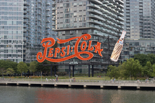New York, NY, USA - July 8, 2022: The Pepsi-Cola sign, a neon sign originally installed atop PepsiCo's bottling factory, is seen at Gantry Plaza State Park in the Long Island City, Queens, New York.