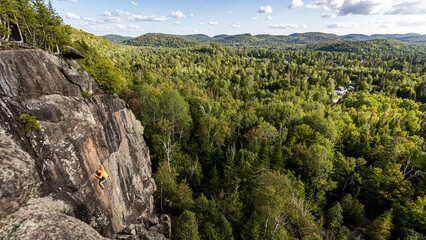 Climber on the wall in the forest