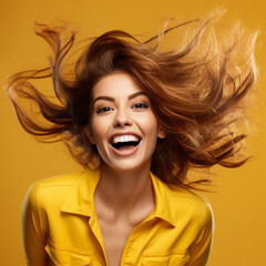 Woman with hair flying on yellow background.