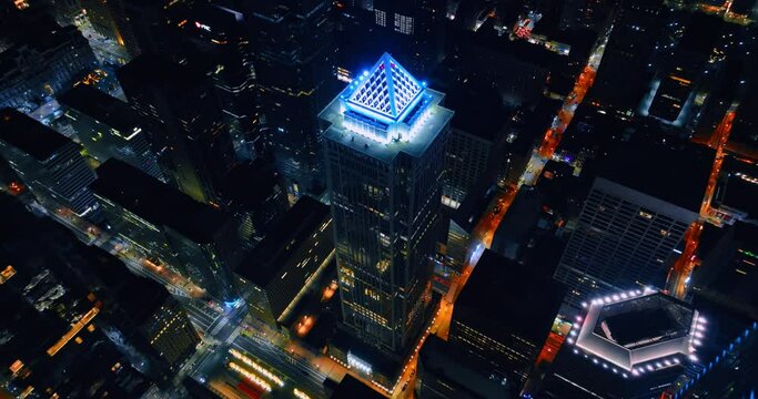 Highlighted top of BNY Mellon Center with white neon light. Distancing from the skyscraper of Philadelphia, Pennsylvania, USA at night.