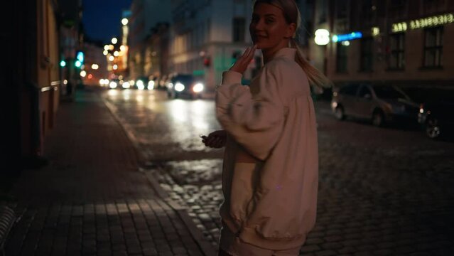 Breathtaking scenes of a beautiful blonde woman enjoying a nighttime stroll and having fun in urban surroundings