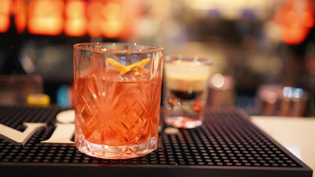 Neon-lit bar setting where cocktails are expertly concocted at night