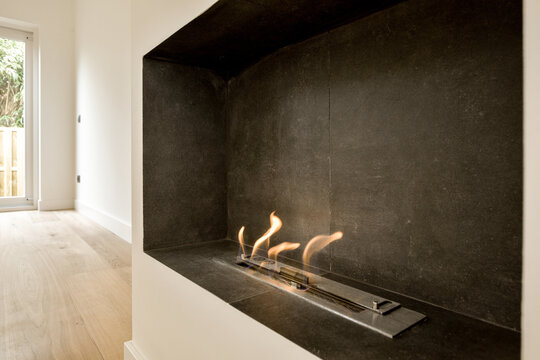 the fireplace in the living room is clad in slate