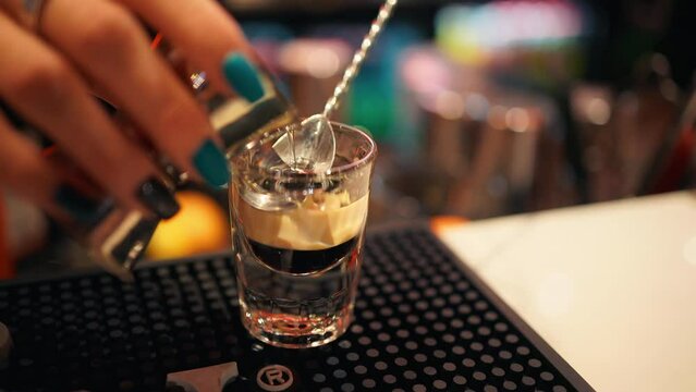 Nifty visuals of a B52 cocktail being made in a lively night bar scene