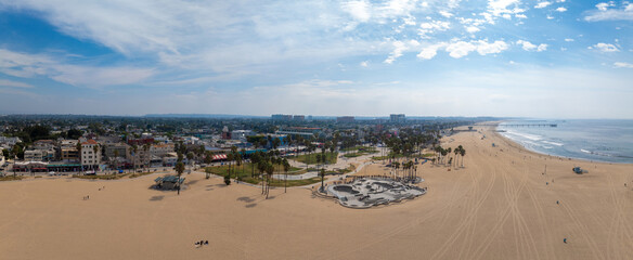 Skate board park in Venice beach with people skating by the Pacific ocean. Best and most popular skate park in the world.