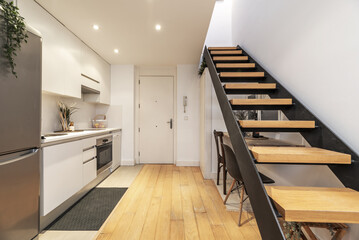 small loft-type house with wooden and metal stairs to access the second floor