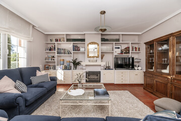 Frontal image of the living room of a single-family home with vintage stoneware floors
