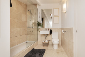 A bathroom with white square porcelain sink with frameless mirror