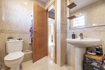A small bathroom with marble-look tiled walls