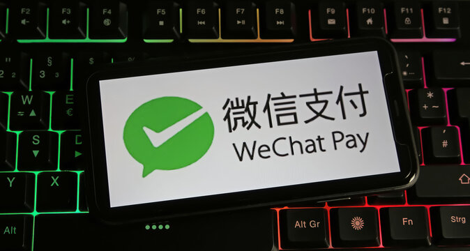 Viersen, Germany - January 9. 2024: Closeup of smartphone on pc keyboard with logo lettering of chinese wechat pay