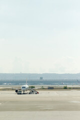 view of airport showing an airplane ready for take-off, airport building, airport facilities.