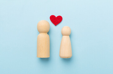 Wooden couple in love on color background, top view. Creative valentine's day composition