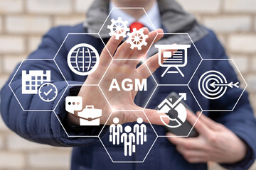 Man using virtual touch screen sees abreviation: AGM. AGM Annual General Meeting Business Concept....