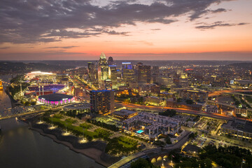 Aerial view of downtown district of Cincinnati city in Ohio, USA at night. Brightly illuminated...