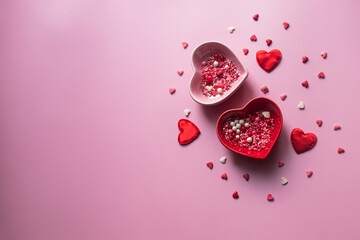 Valentine's Day background. Containers for jimmies in the shape of a heart on a pink background