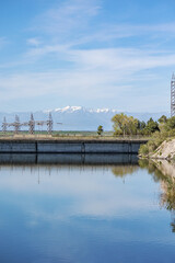 The Tagus river, surrounded by an electric dam, shows cables, mountains, water, vegetation, nature...