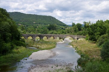 Fototapeta na wymiar Ancient bridge in Ardeche in the south east of France, in Europe