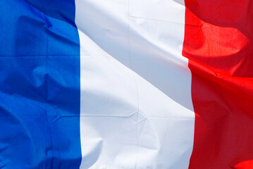 closeup of the national flag of  France, bleu, blanc, rouge, flapping fluttering moving in the wind