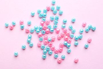 Blue and pink beads on a pink background. Bead making kit and beadwork elements