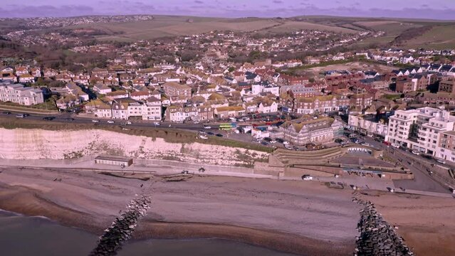 Rottingdean village in East Sussex, aerial video of the white chalk cliffs and the and the high street looking towards the centre of the village.