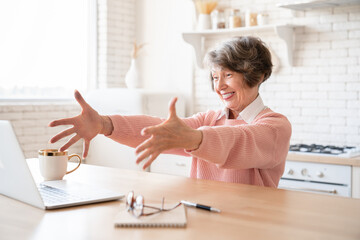 Happy cheerful caucasian grandmother senior old elderly woman winning money lottery, bidding online...